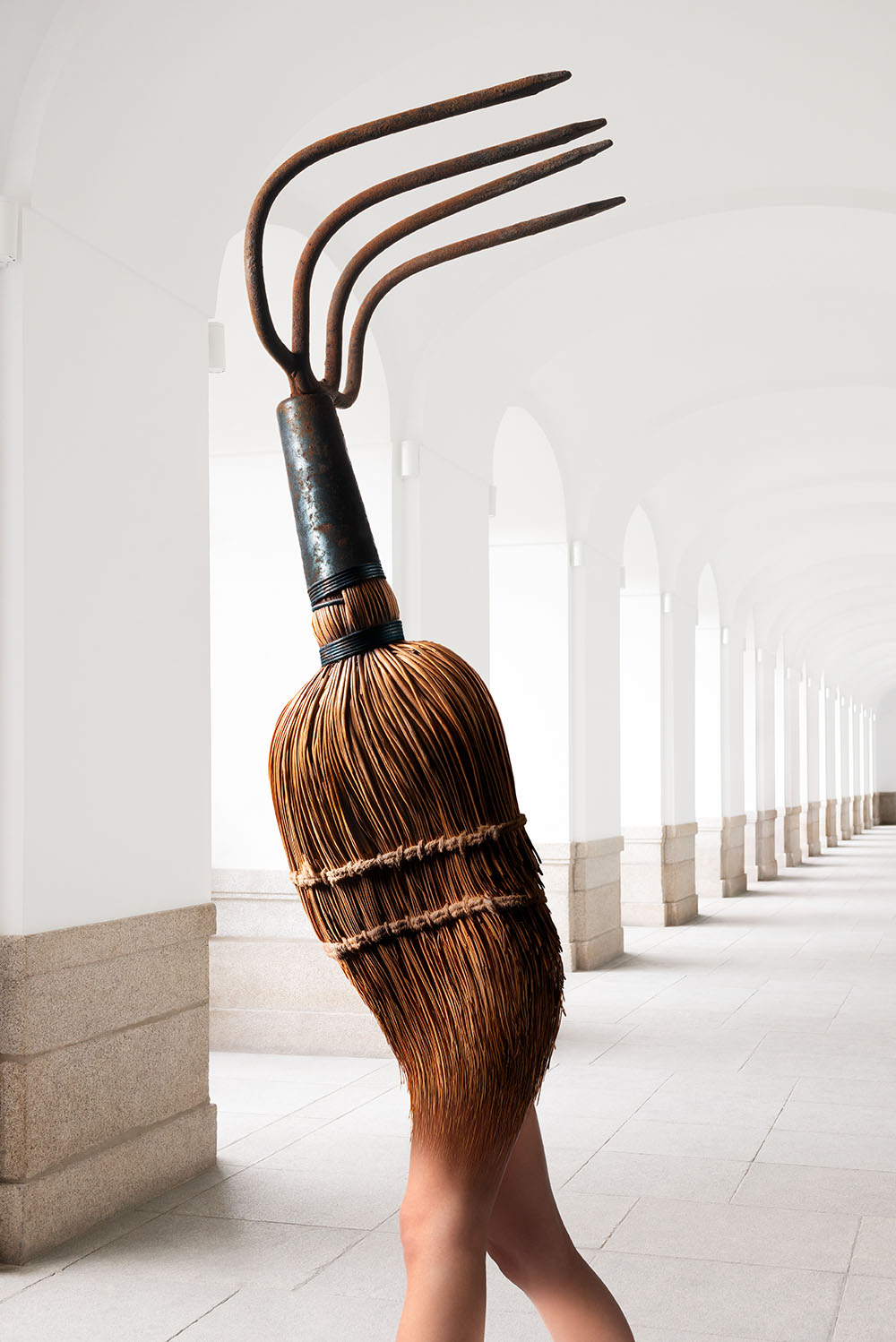 A chimera, with the legs of a woman, the body of a whisk broom, and the head of a garden rake, rushing down a hallway. 