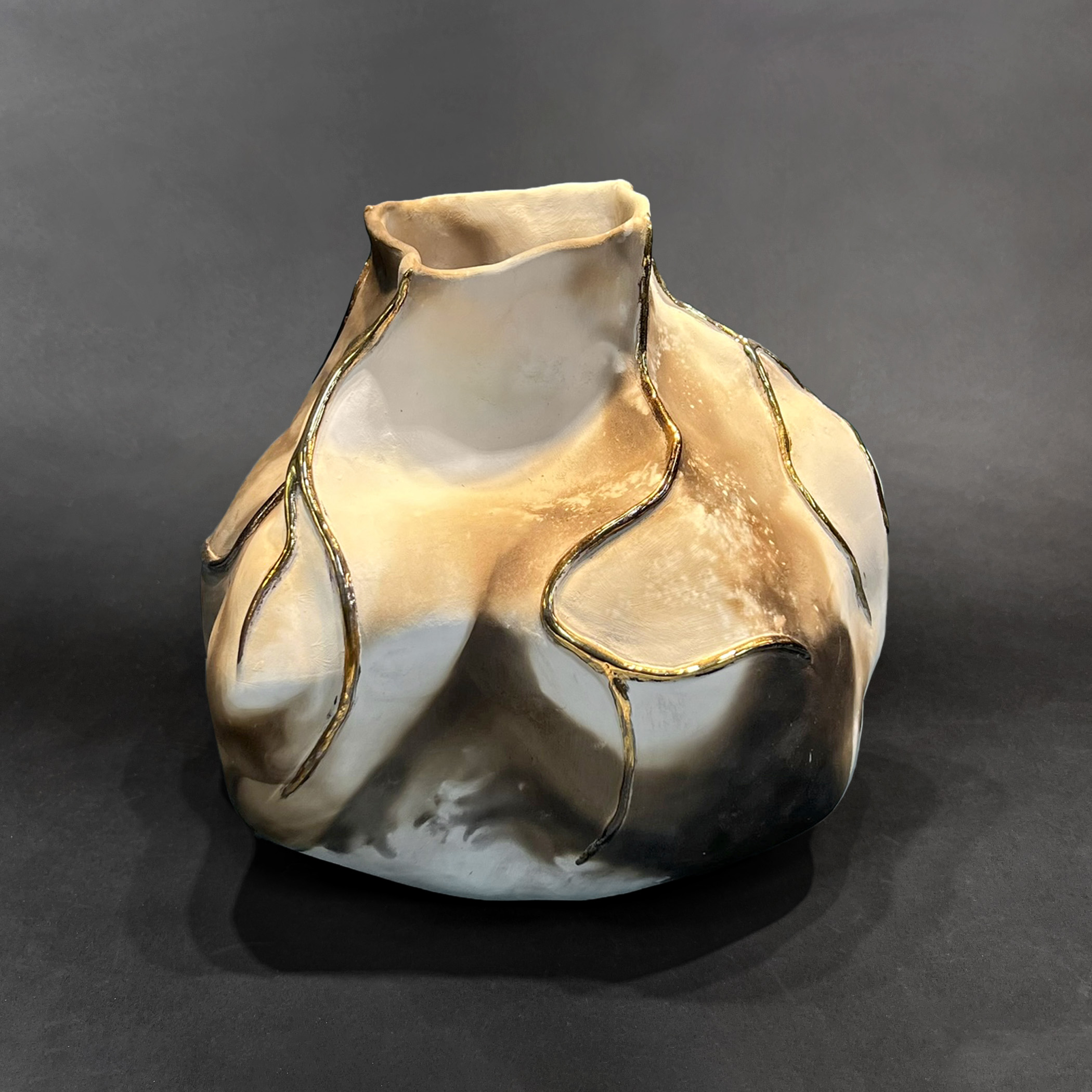 Molten Flow
pit fired, gold lustered porcelain
7" h x 8.5"w x 9" deep