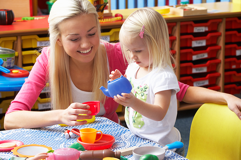 Young woman playing with girl Young woman playing with girl