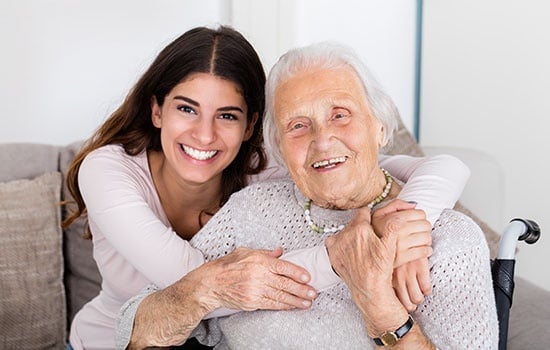 Two Women Embracing Each Other At Home