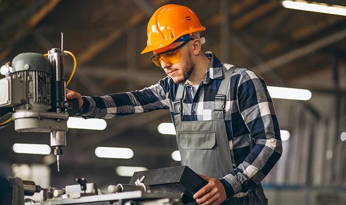 Dos mujeres sonriendo en una oficina moderna, una sosteniendo una tableta.
