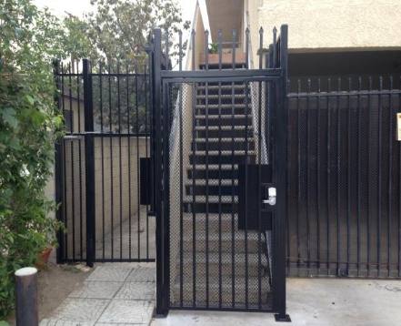 Black iron fence around stairs with locked entry.