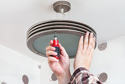 Electrician Mounts Round Ceiling Light