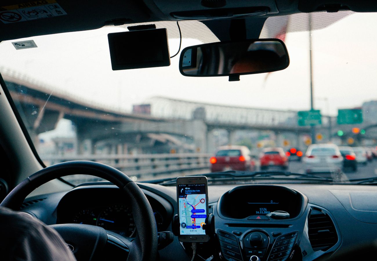 Person using navigation to drive a car