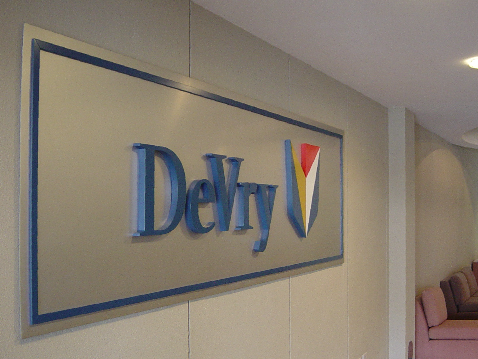 laser cut letters & logo on aluminum panel reading DeVry