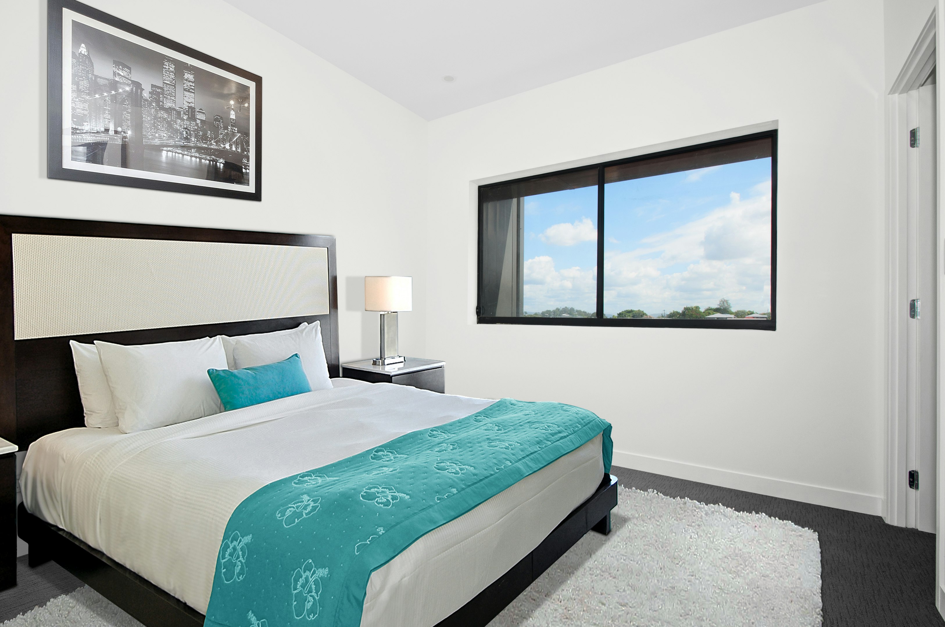 white bedspread and black wooden bed