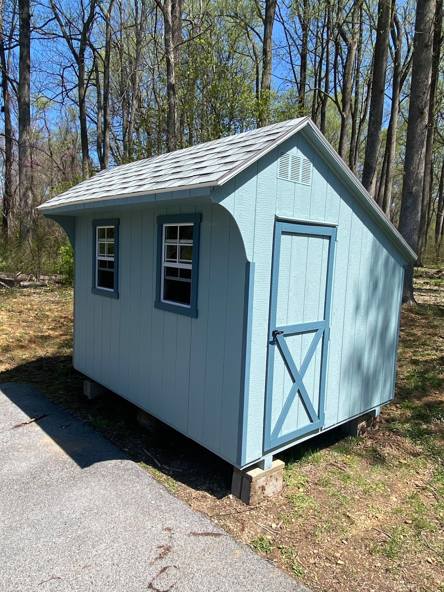 8 x 10 Chicken Coop                    
                                                              
Featuring light blue colored wood siding, blue colored trim, and gray colored 30 year architectural shingles (with tarpaper underlayment).

Standard features include:
1-30” entry door, gable vents, 2-18”x27” slider windows with screens, pressure treated floor joists, laying boxes, 1-chicken Door, perches, your choice of color combinations, 30 year architectural shingles with tar paper underlayment.