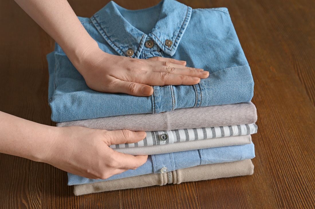 Women Handing Folded Clothes Women Handing Folded Clothes