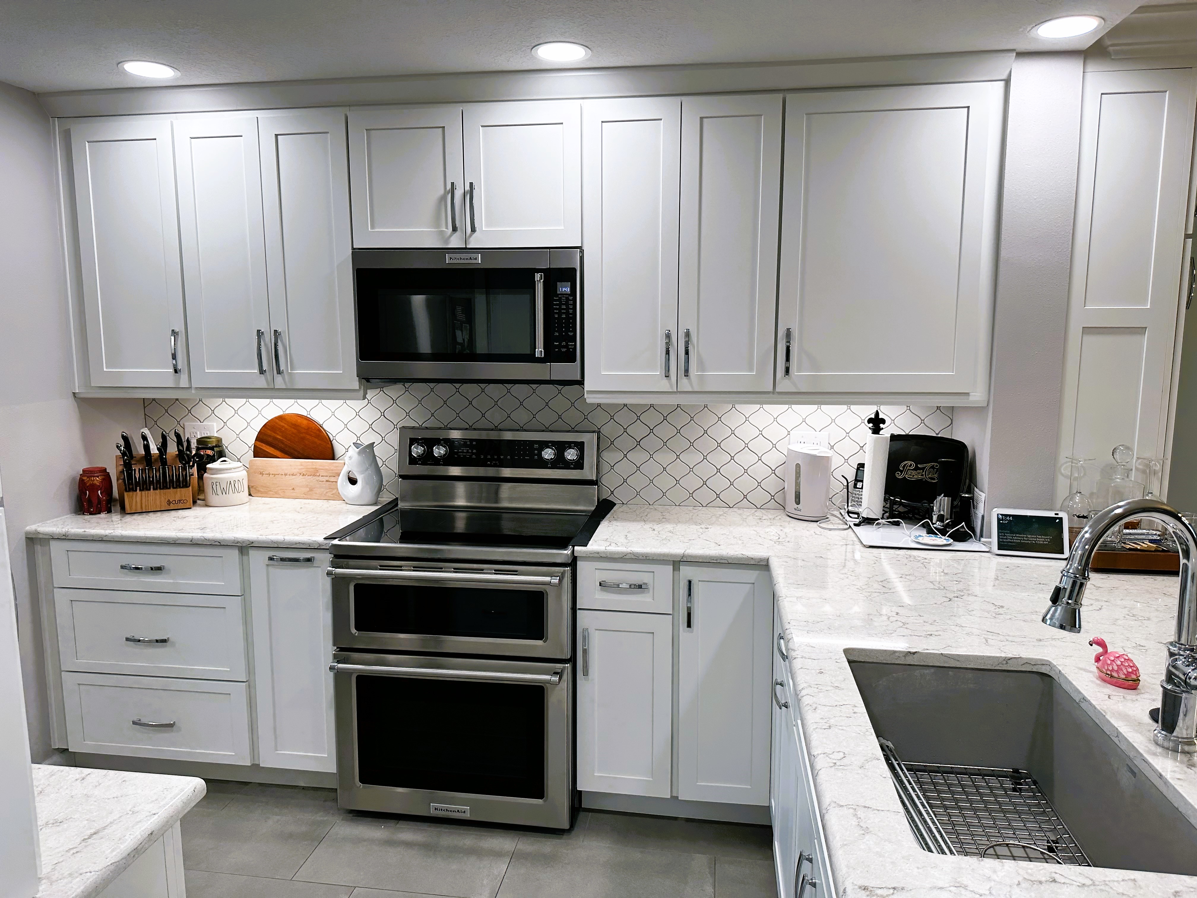 Bright spacious kitchen featuring quartz countertops and backsplash with plenty of room for cooking.