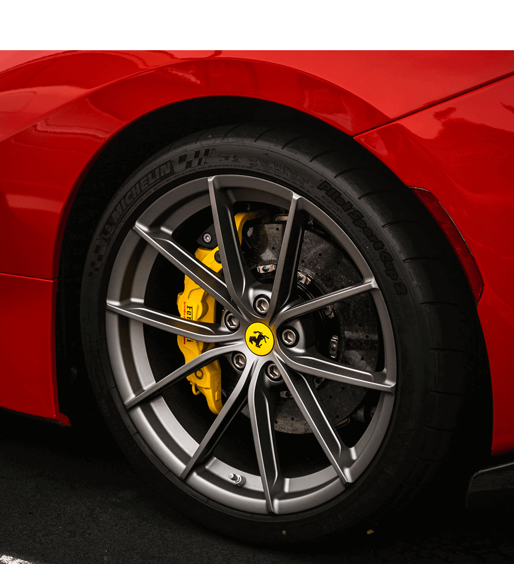 the wheels to a red Ferrari