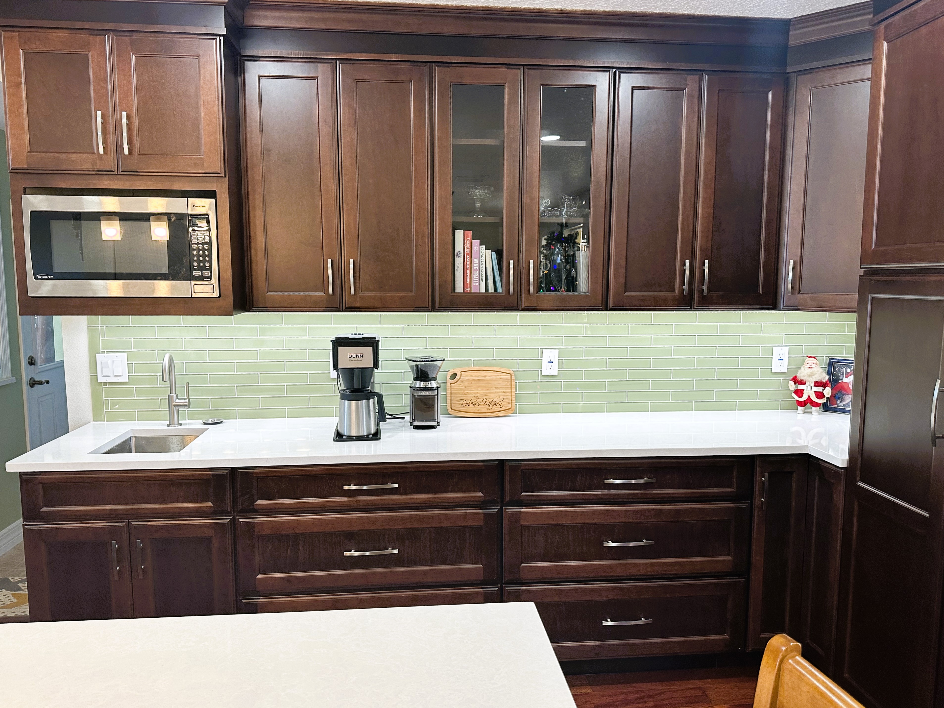 Stunning kitchen featuring Brandywine-stained cabinetry, Cambria quartz countertops, and satin nickel hardware.  