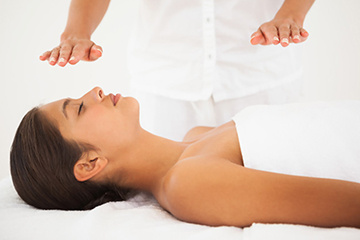 Woman in white receiving reiki