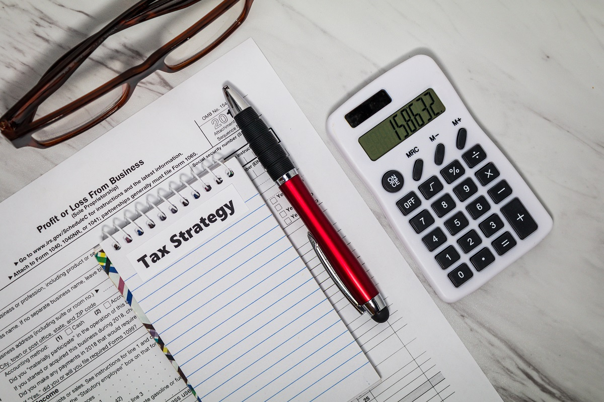 Tax paperwork, calculator, and pen