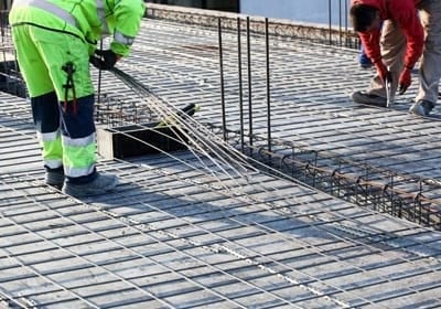 Workers Make Reinforcement for Concrete Foundation
