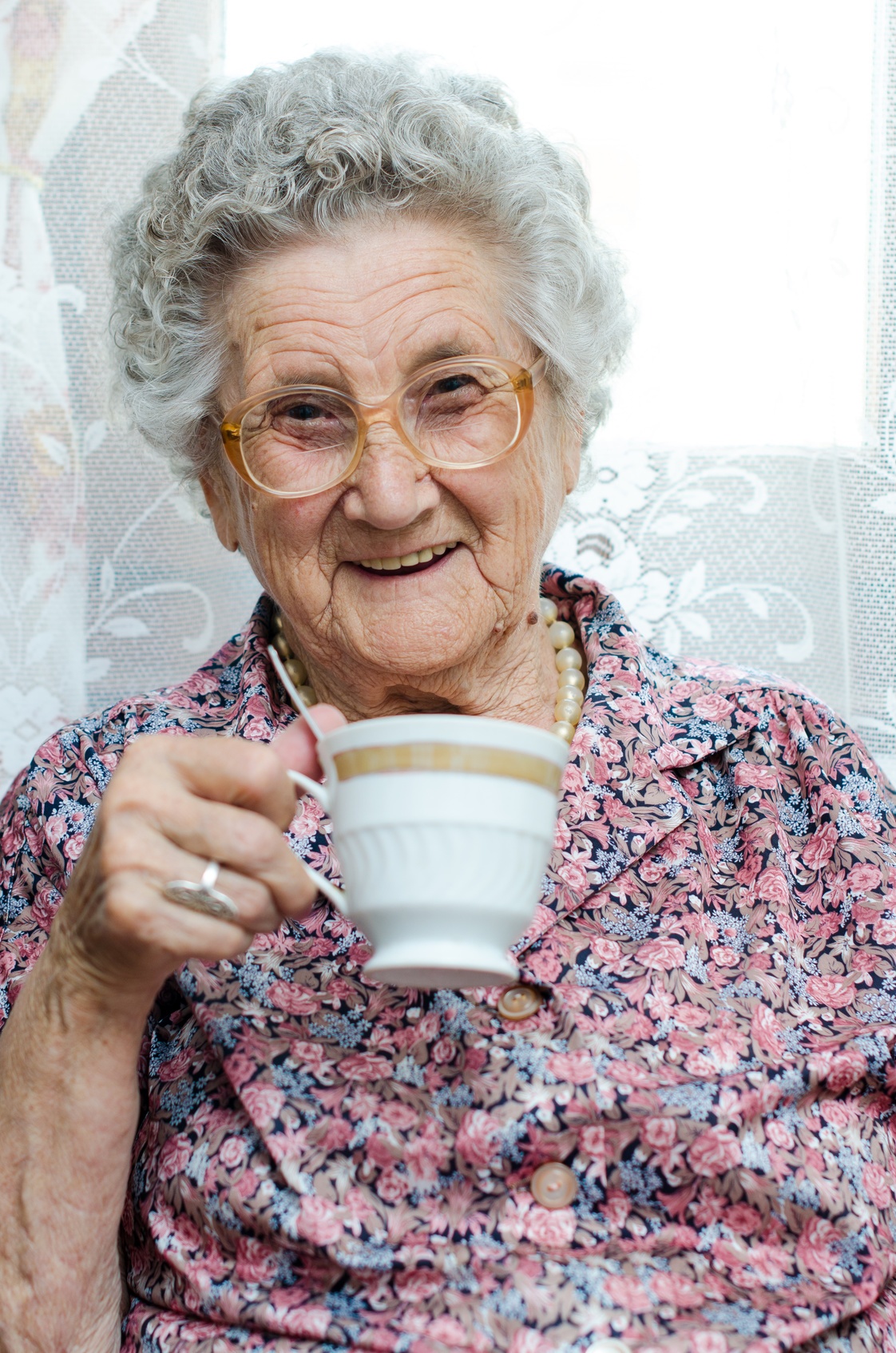 Old Lady Holding a Cup