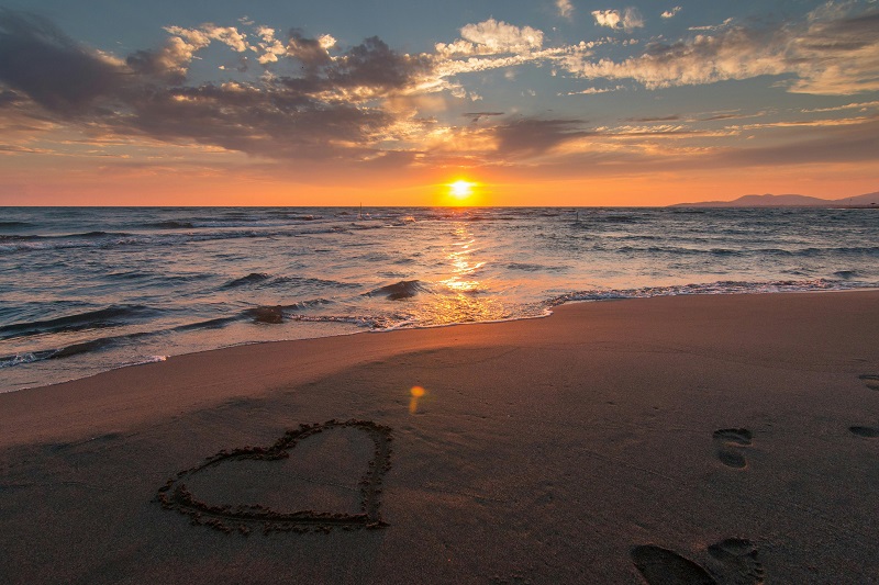 Beach with a heart drawn in the sand