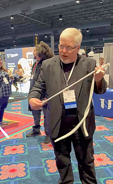 Chuck Thomas performing interactive magic for a corporate trade show audience. Chuck Thomas performing interactive magic for a corporate trade show audience.