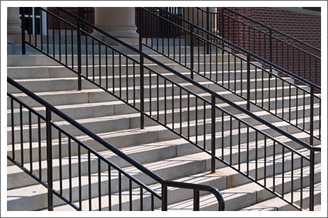 Stairway with black railing||||