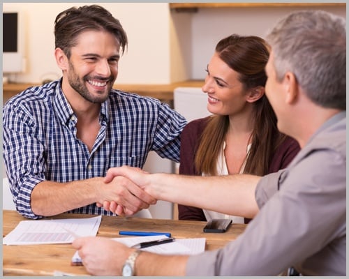 Couple Shaking Hand To Financial Agent
