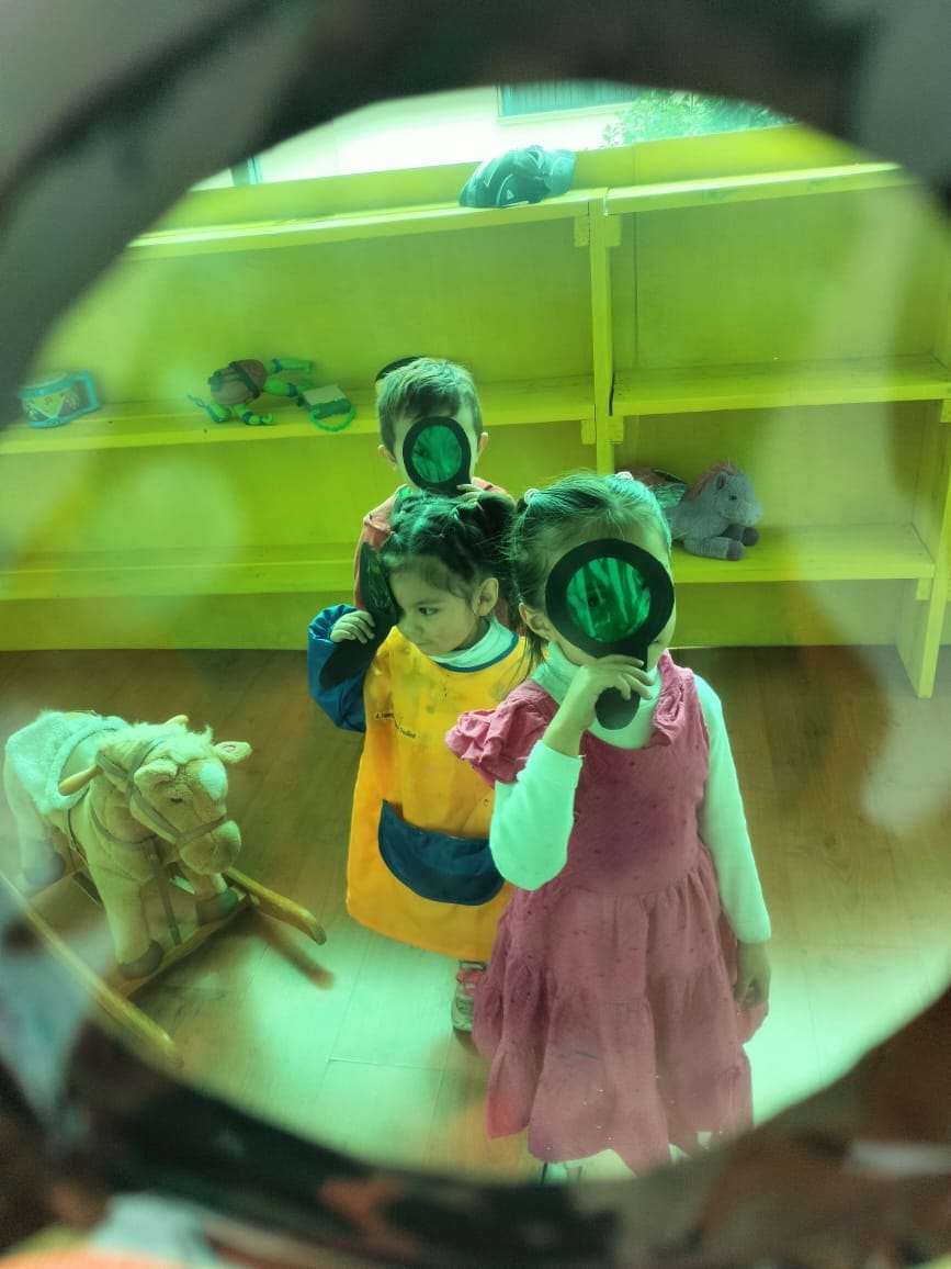 a small black and white dog sitting next to a teddy bear a small black and white dog sitting next to a teddy bear