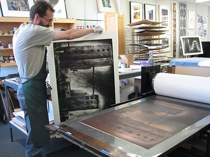 Printer David Avery pulling a print of Jenny Robinson's Third Street Factory