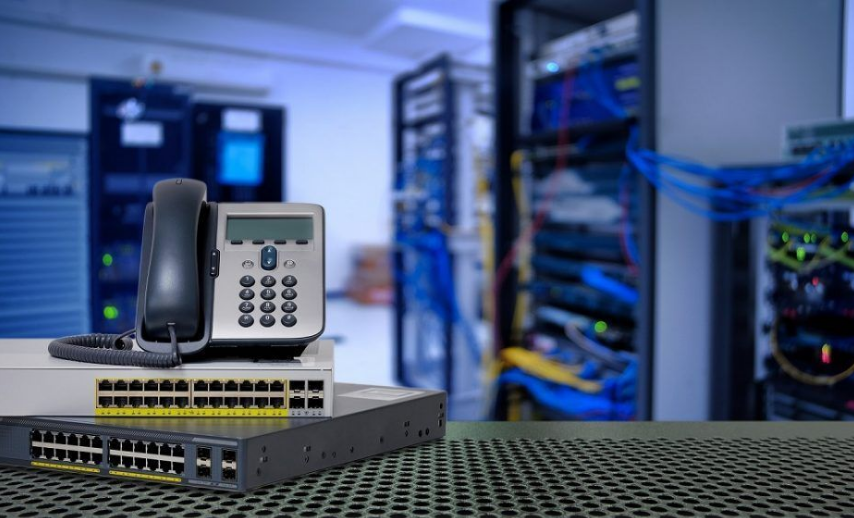 Person holding an iPhone in front of a MacBook