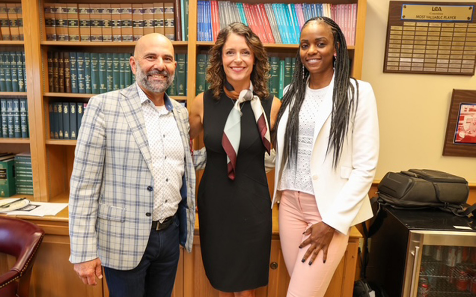 Three people posing in an office