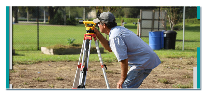A man using surveyor equipment