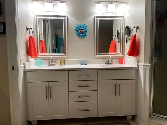 Classic and clean vanity featuring double sinks and mirrors with brush nickel hardware.
