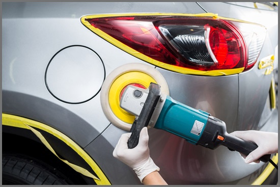 Worker Waxing Grey Car