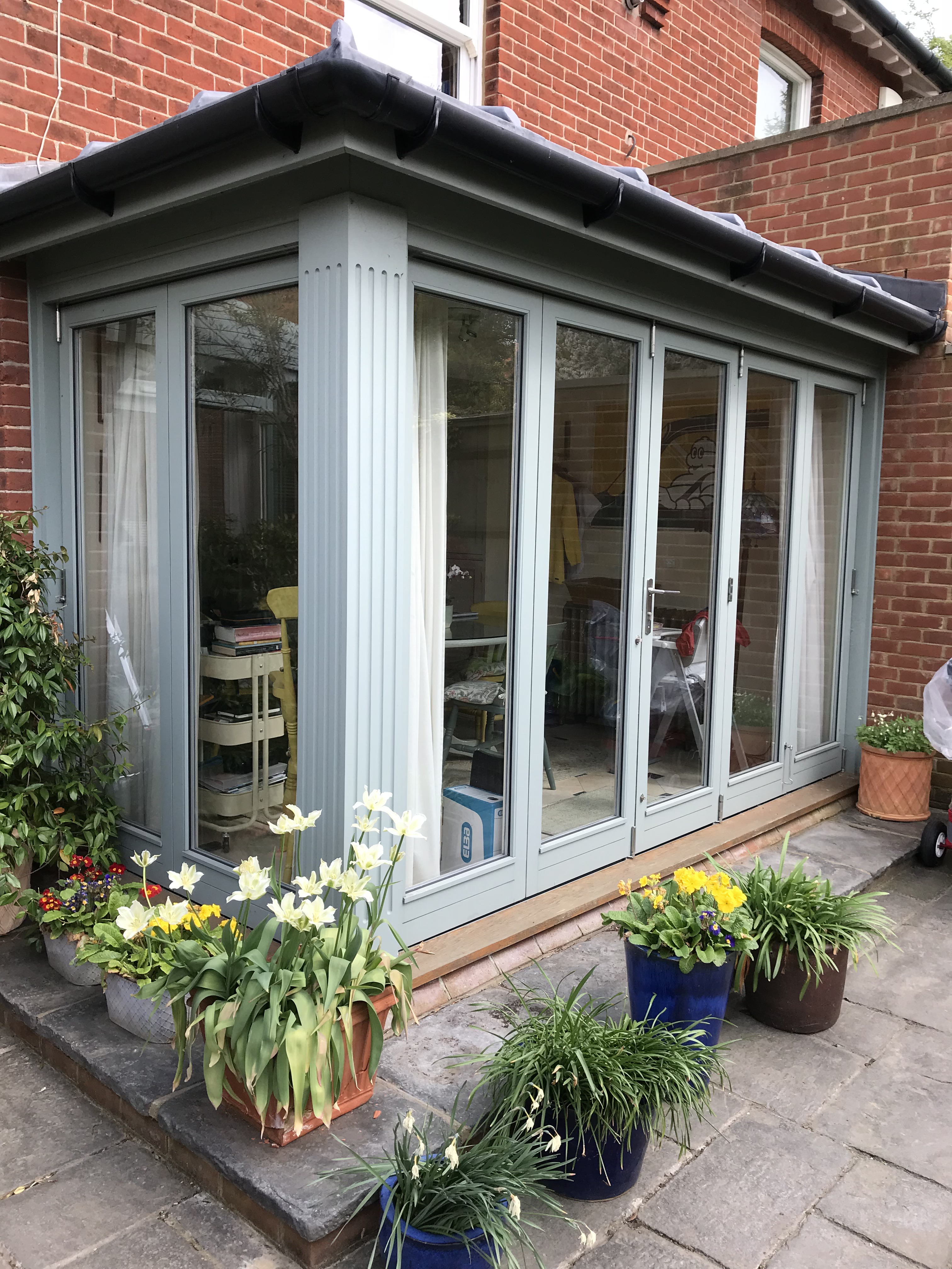 a room with a table chairs and a lamp
