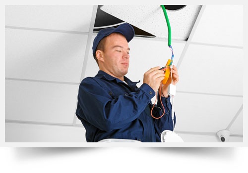 Electrician Checking Voltage in Office