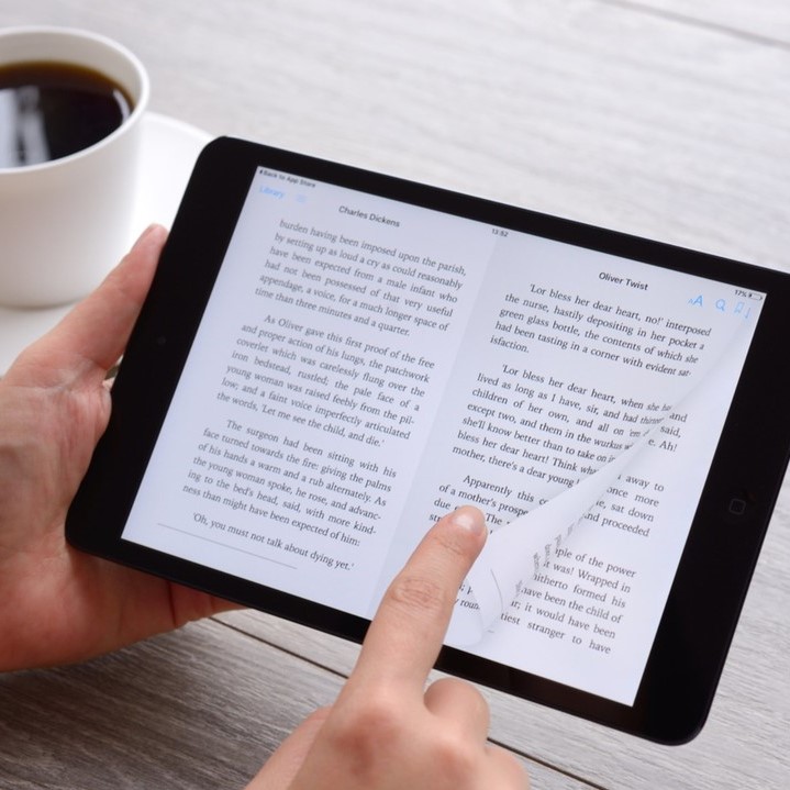 Smiling professional woman in business attire engaged in a conversation in a modern office setting.