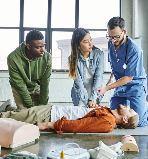 Medical staff training CPR on a dummy Medical staff training CPR on a dummy