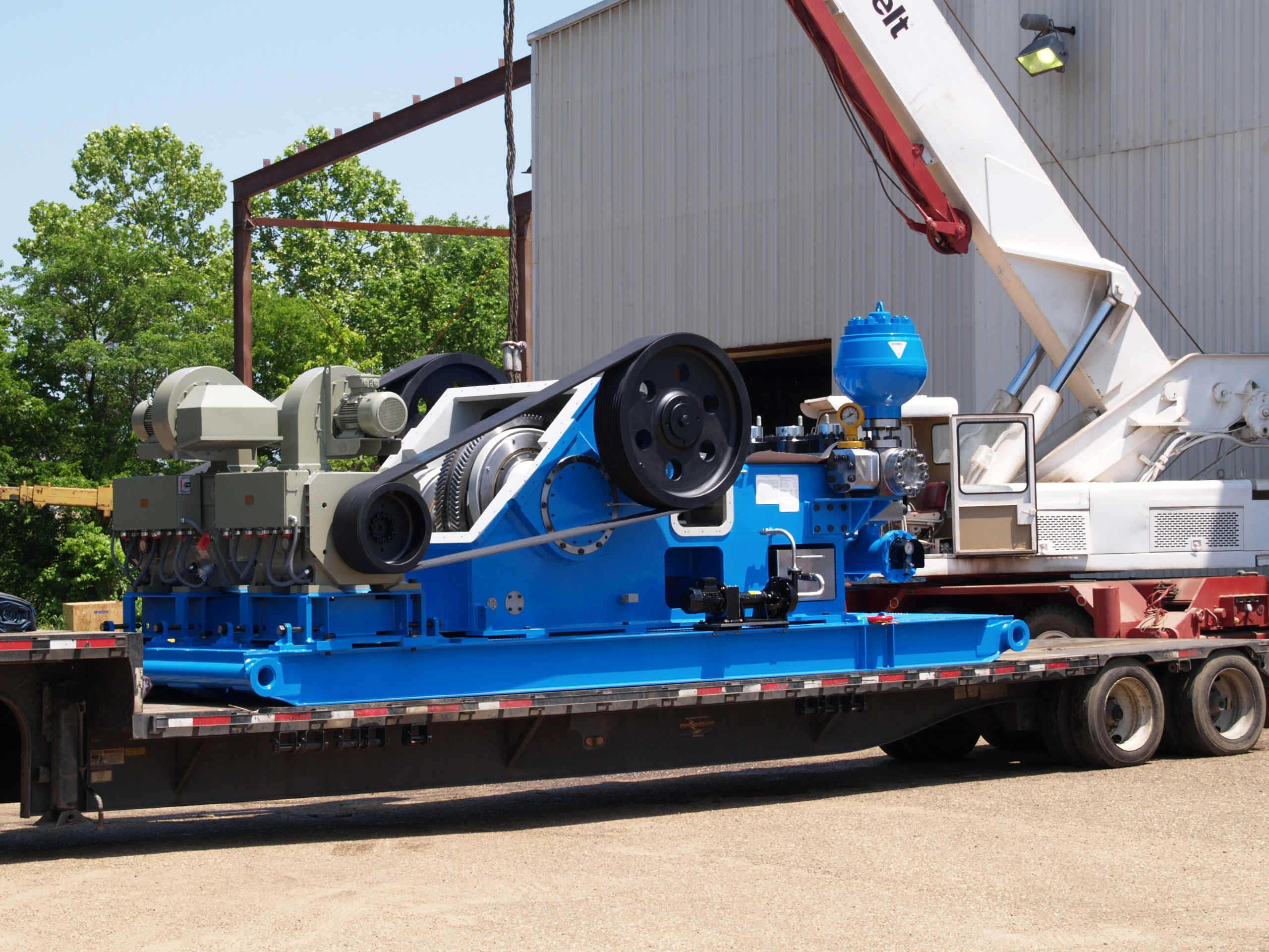 Close-up of a CNC machine in operation, cutting metal with precision in an industrial setting.