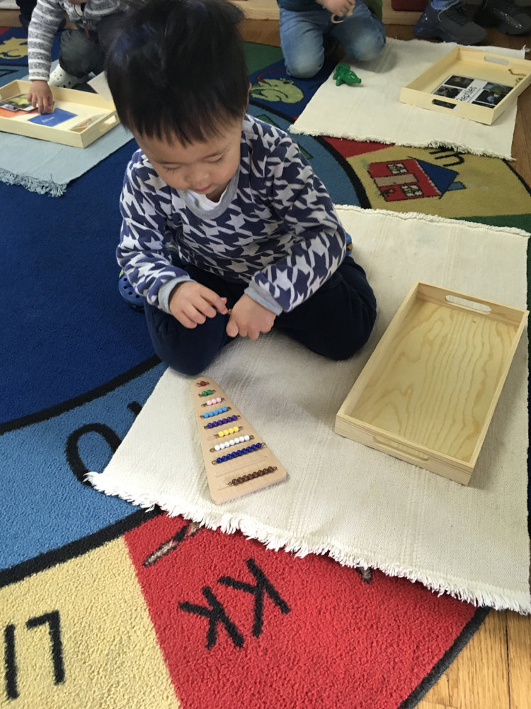 A young student playing with a learning toy