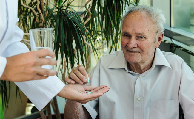 Elderly Man Takes Medication