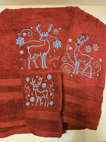 Red towel set featuring blue deer design