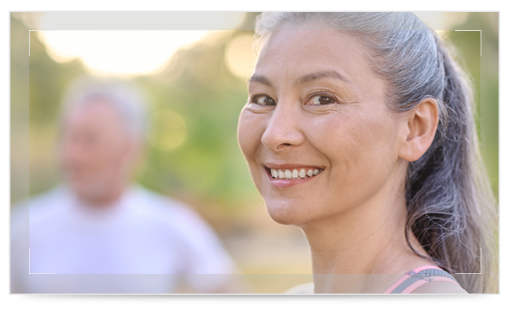 A senior man and woman smiling outside
