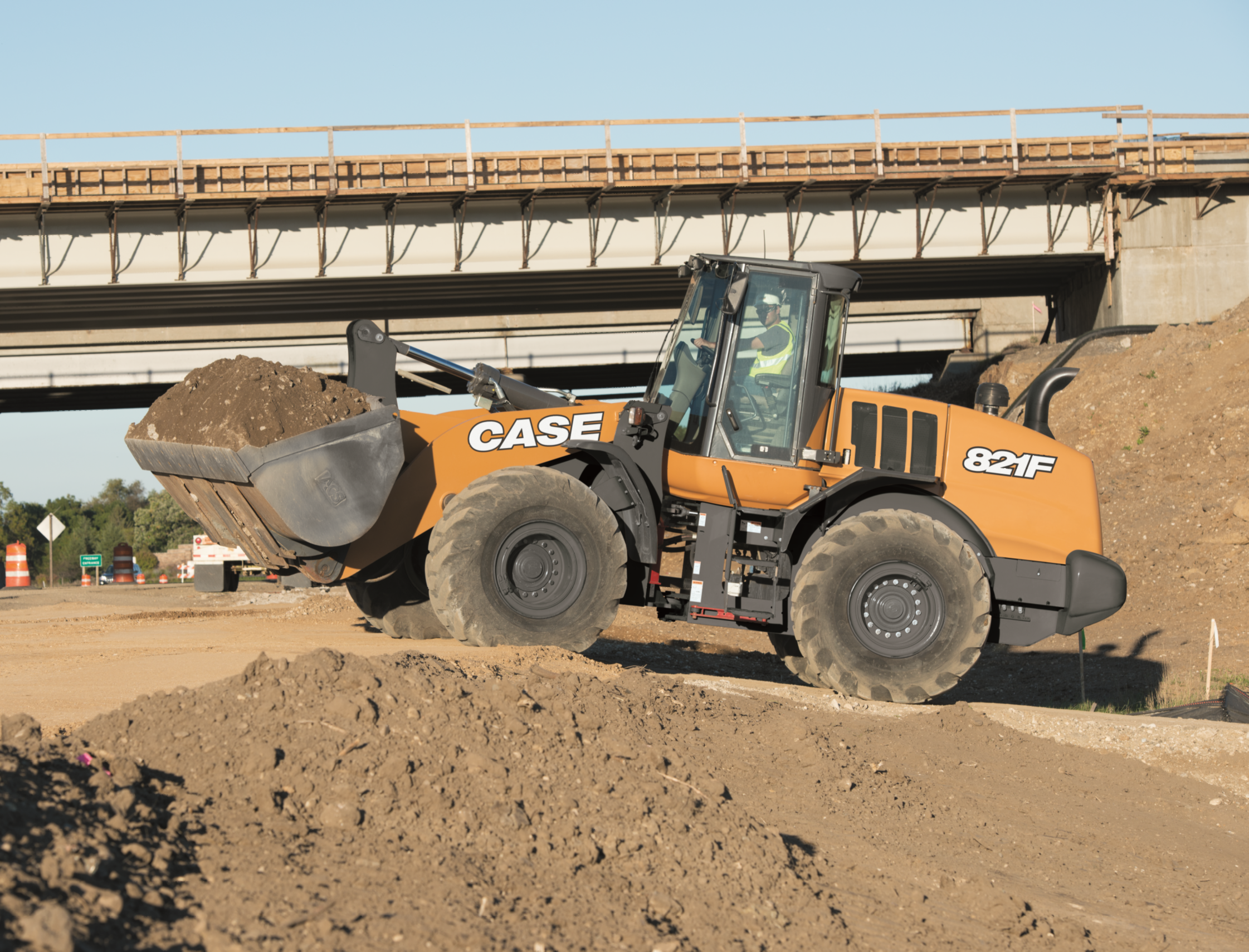 yellow and black heavy equipment on brown field during daytime yellow and black heavy equipment on brown field during daytime