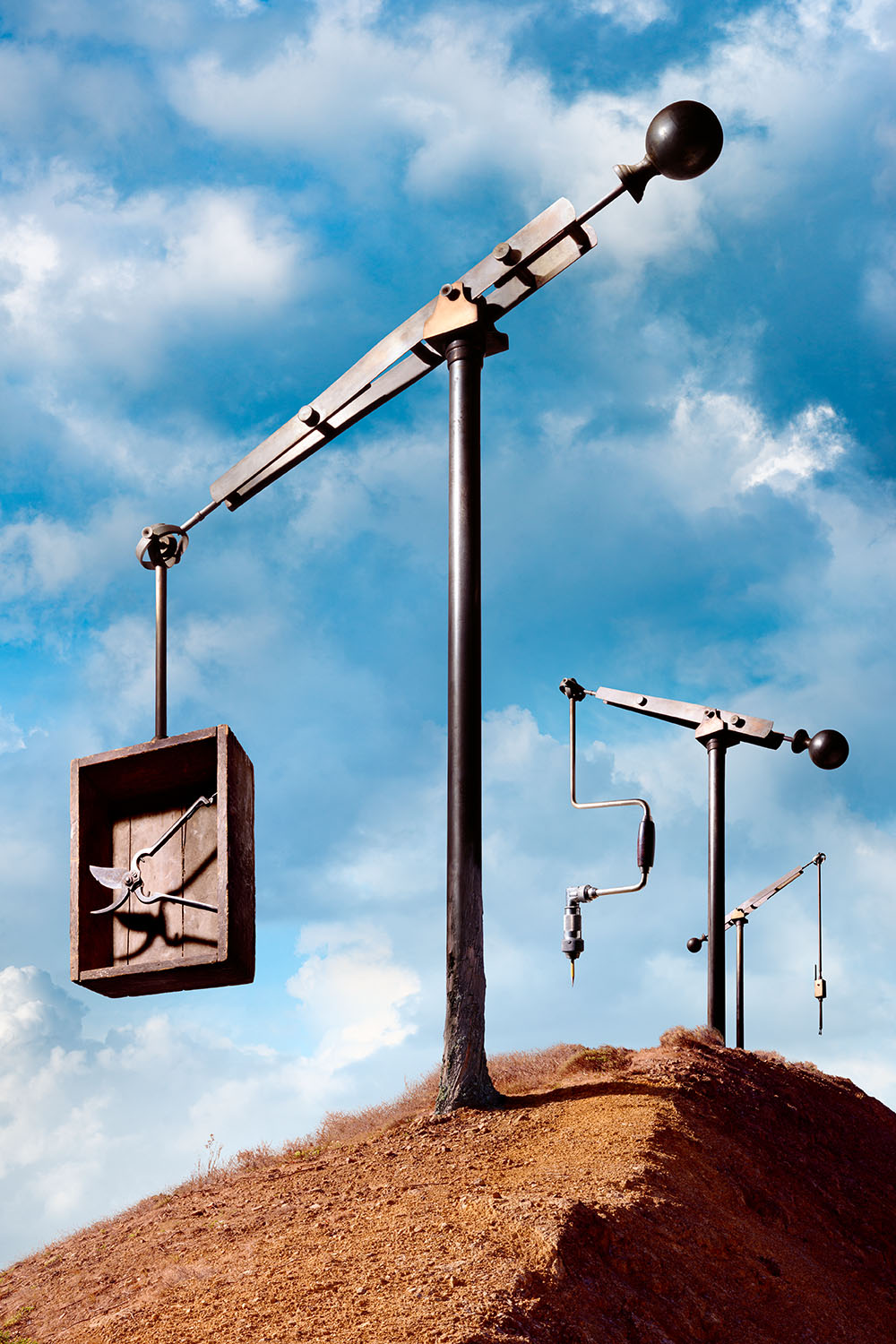 Fantastical landscape with pivoting cranes made of vintage machine parts.