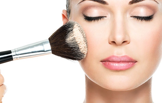 Woman Applying Dry Cosmetic Tonal Foundation On The Face