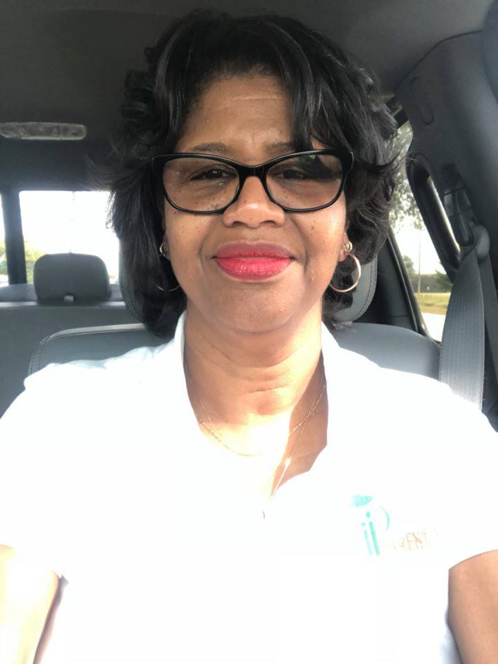 Four business professionals having a meeting in a modern office with laptops and documents on the table.