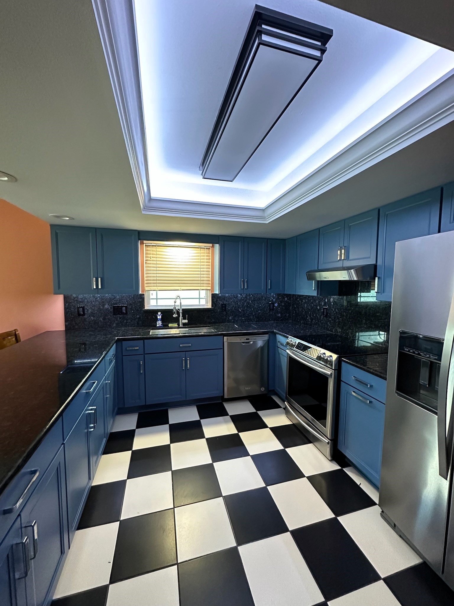 Unique and fun kitchen featuring semi-custom cabinetry pained Lake Shore Blue with gorgeous granite countertops and matching full back splash.  
Trimmed out dome ceiling with pained white crown molding makes this kitchen pop.