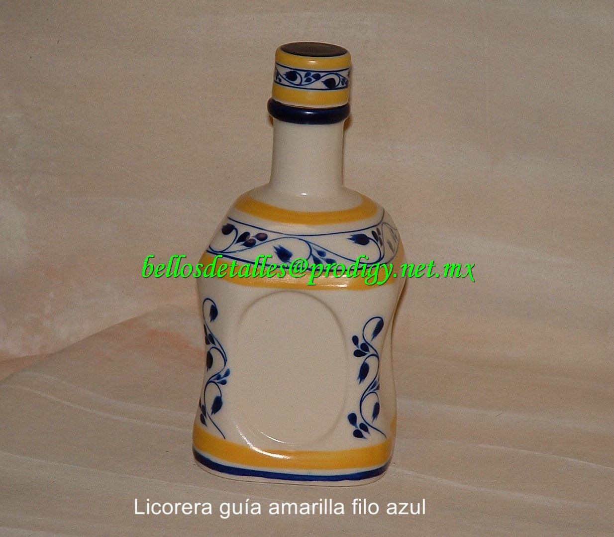 https://0201.nccdn.net/4_2/000/000/081/4ce/Licorera-gu--a-amarilla-filo-azul-1234x1079.jpg