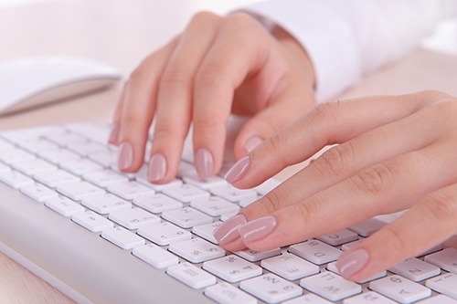 Female Typing on Keyboard