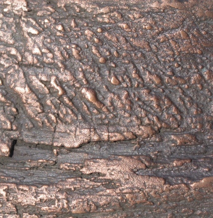 Textured bronze metal finish on driftwood Artistic Metals