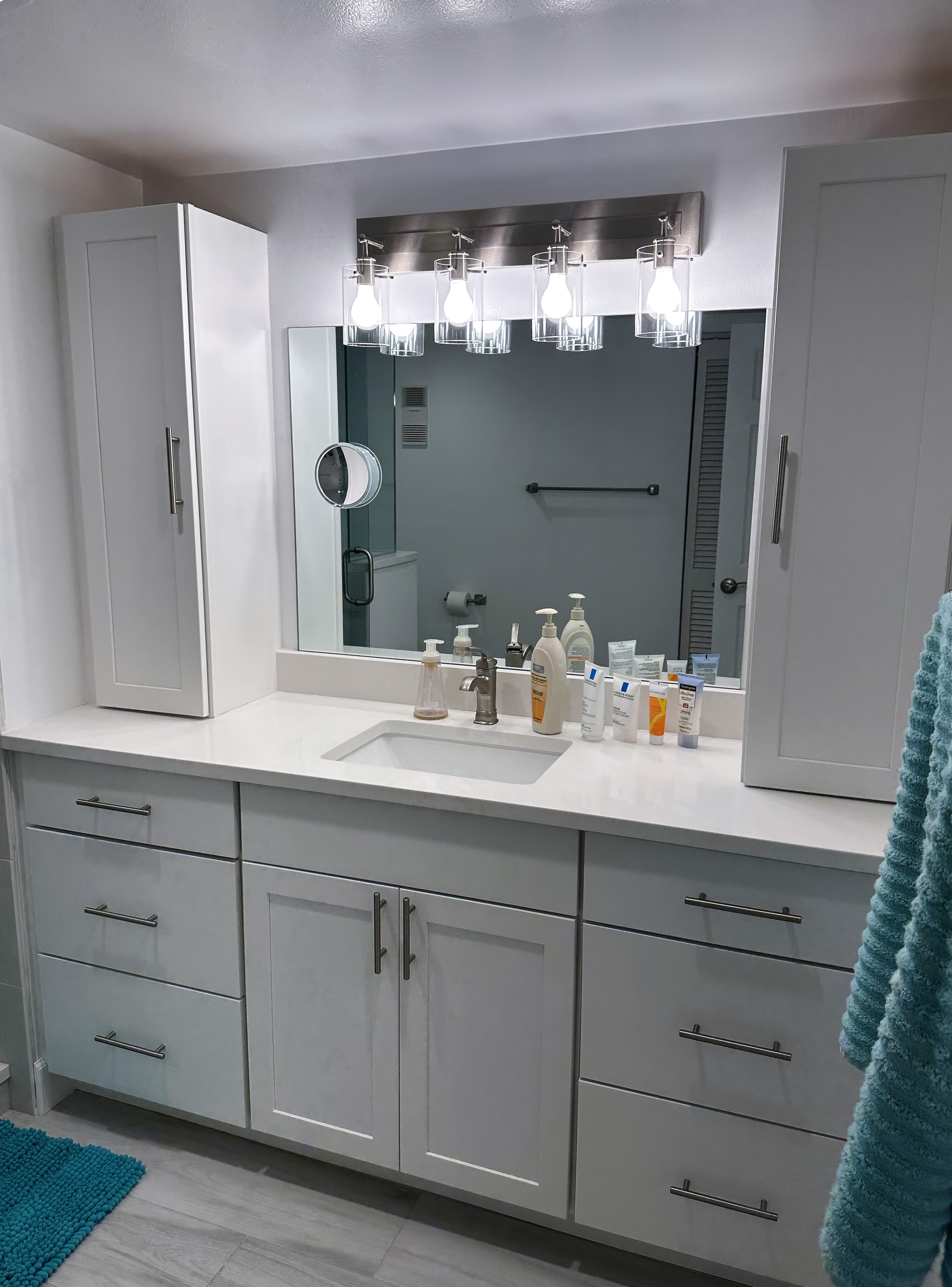 Classic maple shaker door style vanity painted white with extra storage featuring brush nickel hardware.