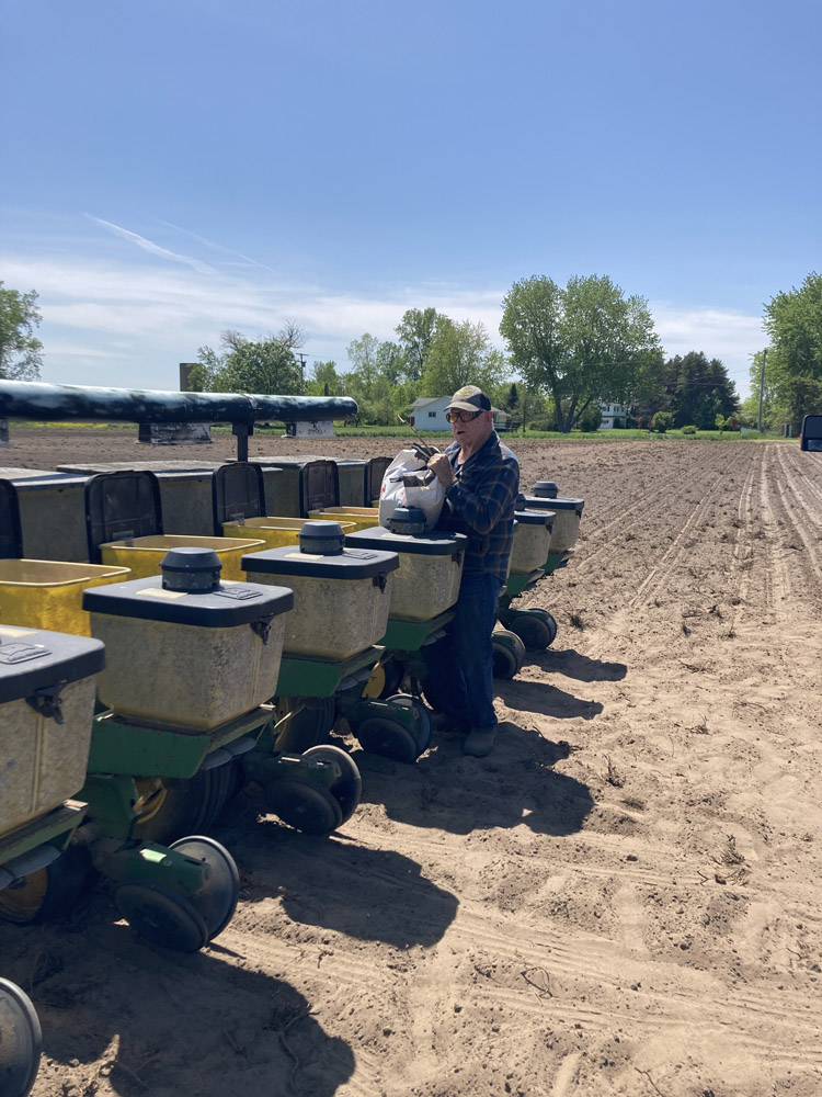 Farmer putting seed in planter