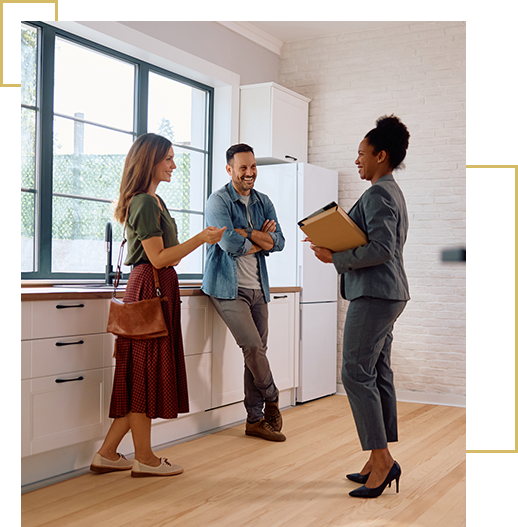 Happy black real estate agent and a couple in the kitchen of a new house.